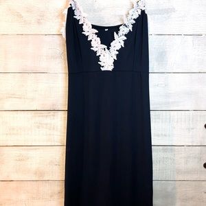 Woman’s navel blue dress with white crochet trim.